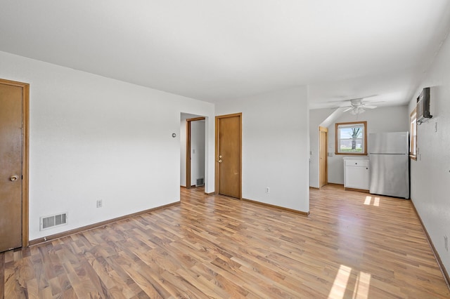 unfurnished room with light wood-style floors, a ceiling fan, and baseboards