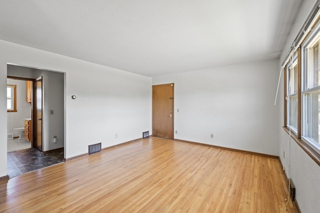 spare room featuring light wood finished floors