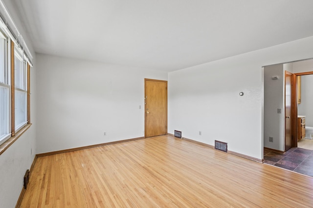 unfurnished room with wood finished floors and baseboards