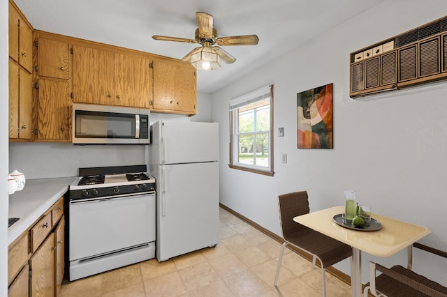 kitchen featuring white appliances, light countertops, baseboards, a ceiling fan, and brown cabinets