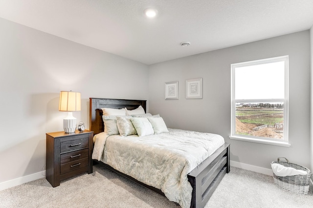 bedroom with light colored carpet