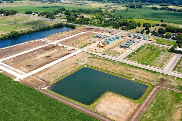 birds eye view of property featuring a water view and a rural view