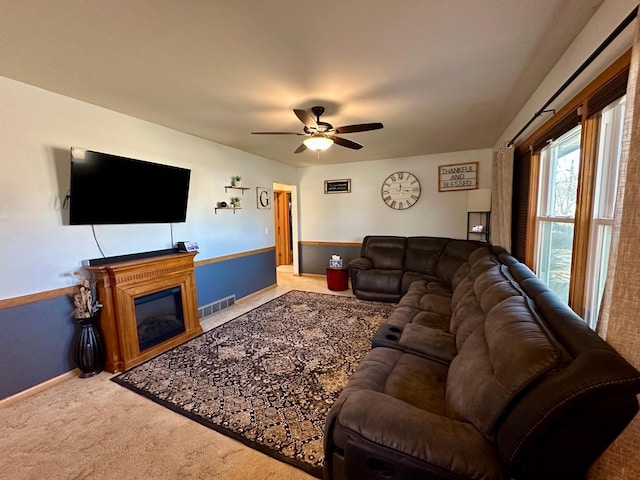 living room featuring carpet floors and ceiling fan