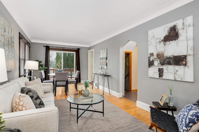 living room with hardwood / wood-style flooring and crown molding