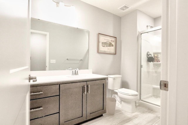 bathroom with vanity, toilet, and walk in shower