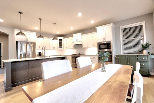 dining area with sink and light wood-type flooring