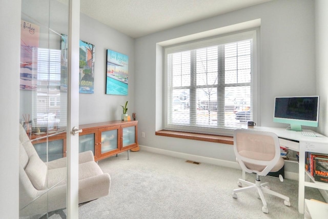 office space with french doors, a textured ceiling, and carpet