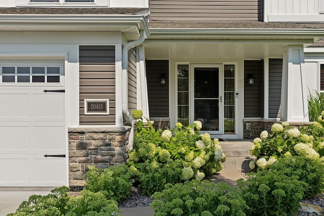 property entrance with a garage and covered porch