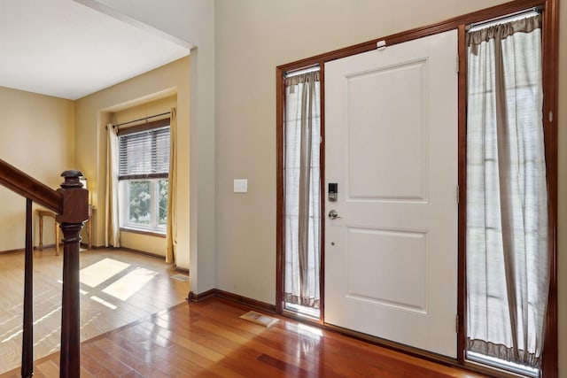 foyer entrance with hardwood / wood-style floors