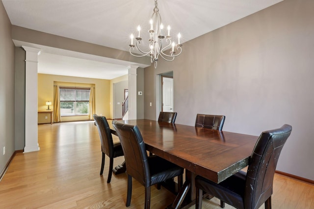 dining area with light wood-type flooring and ornate columns