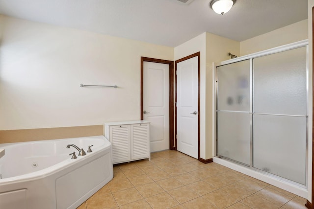 bathroom featuring tile patterned flooring and shower with separate bathtub