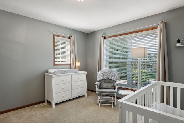 carpeted bedroom with a crib