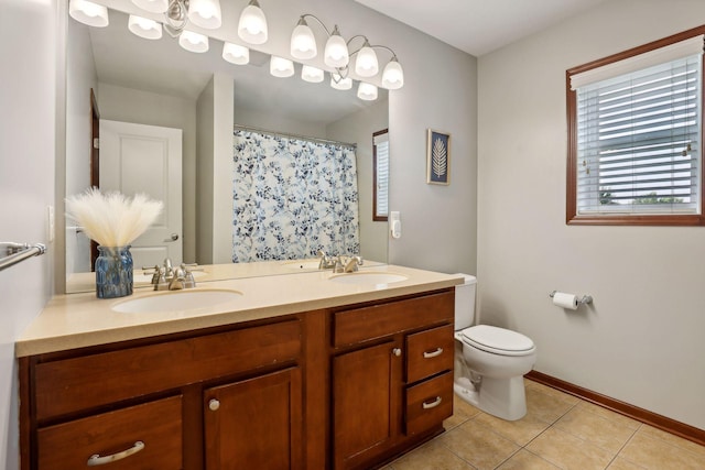 bathroom featuring vanity, tile patterned flooring, and toilet