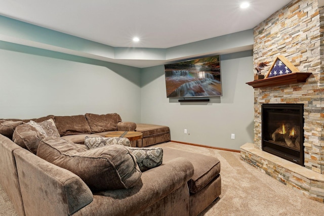 living room with a stone fireplace and carpet