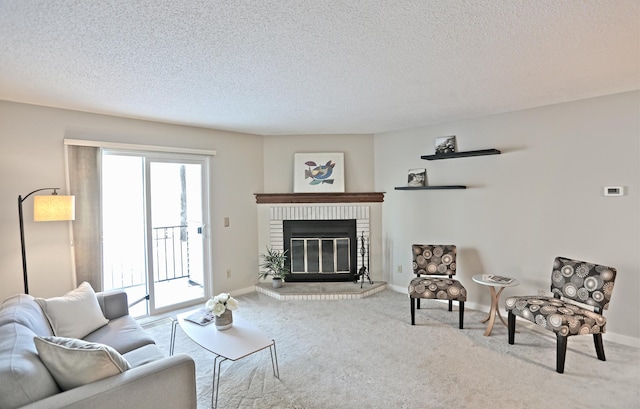 carpeted living area featuring a fireplace, a textured ceiling, and baseboards