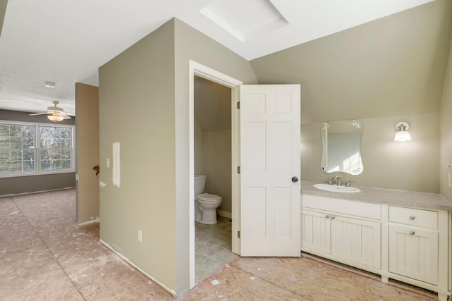 bathroom with vaulted ceiling, vanity, toilet, and ceiling fan