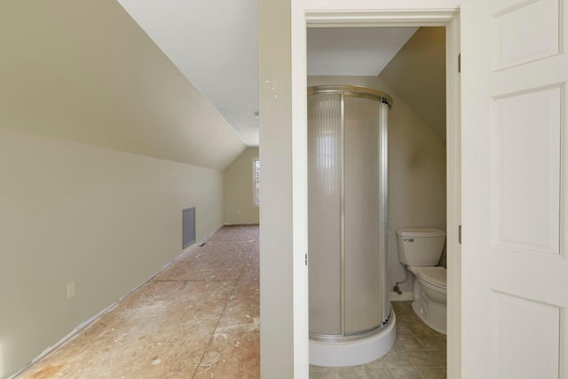 full bathroom featuring lofted ceiling, a stall shower, visible vents, and toilet