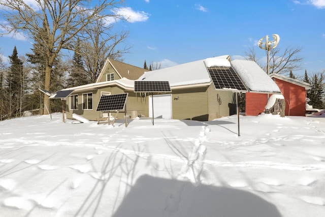 view of front facade featuring a garage and solar panels