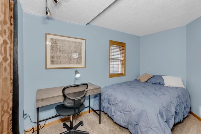 carpeted bedroom featuring a textured ceiling