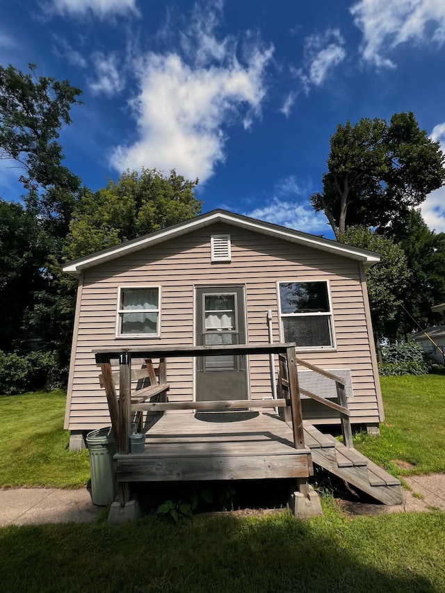 view of front facade with a deck and a front lawn