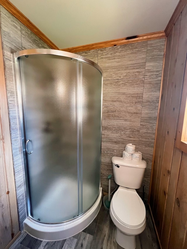 bathroom featuring an enclosed shower, crown molding, toilet, and hardwood / wood-style flooring