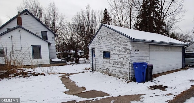 exterior space featuring a garage and an outbuilding