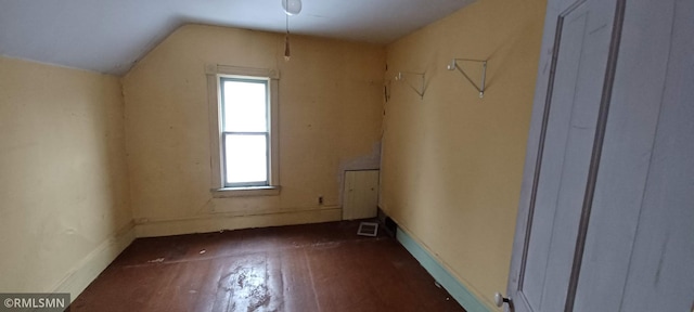 bonus room featuring vaulted ceiling and dark hardwood / wood-style floors