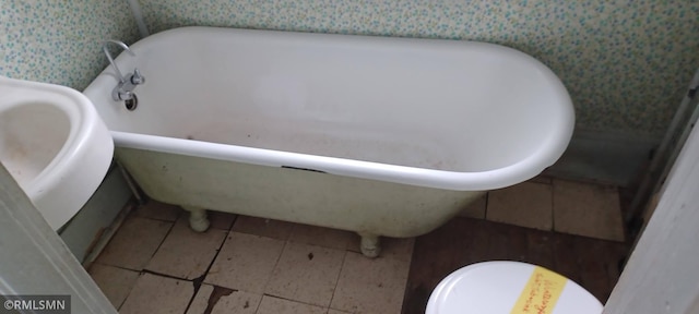 bathroom featuring tile patterned flooring and a tub