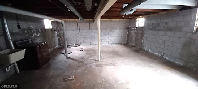 basement featuring washer / dryer and sink