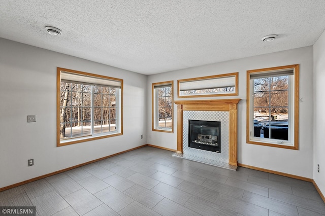 unfurnished living room featuring a tiled fireplace