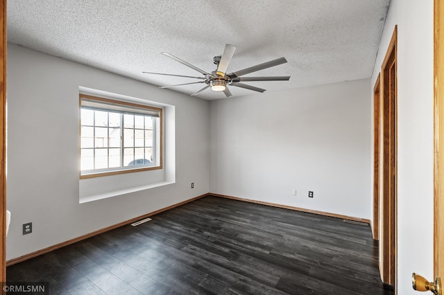 unfurnished room featuring ceiling fan, dark hardwood / wood-style flooring, and a textured ceiling