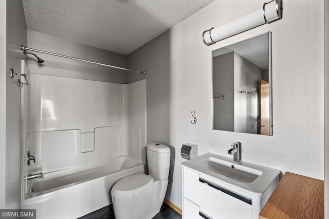 full bathroom featuring vanity, toilet, shower / bathtub combination, and a textured ceiling