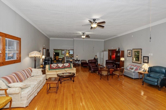 living room with a textured ceiling, crown molding, and hardwood / wood-style floors