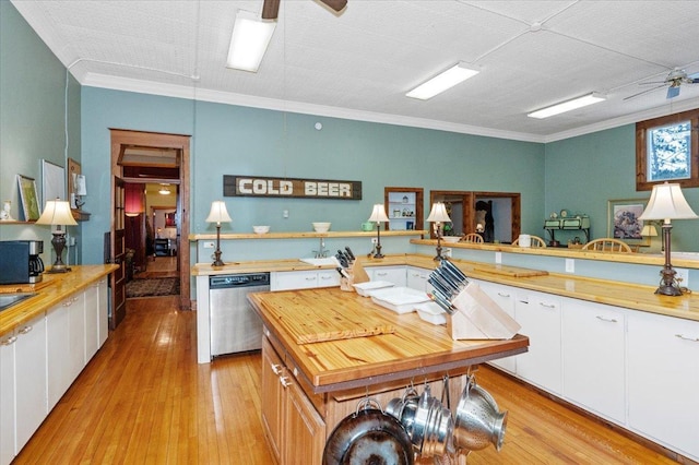 kitchen featuring dishwasher, white cabinetry, and ornamental molding