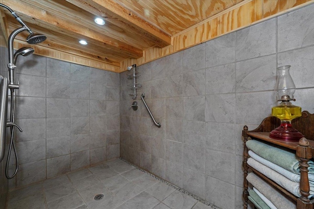 bathroom with wood ceiling, beamed ceiling, and tiled shower