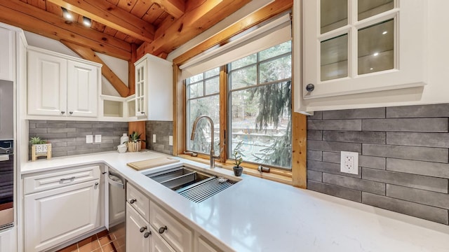 kitchen featuring dishwasher, white cabinetry, sink, backsplash, and wooden ceiling