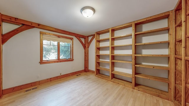 additional living space with lofted ceiling and light hardwood / wood-style floors