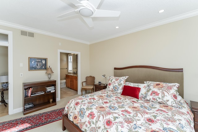 carpeted bedroom with a ceiling fan, connected bathroom, visible vents, and crown molding