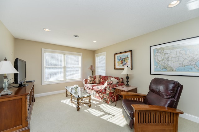 living room with recessed lighting, baseboards, and light colored carpet