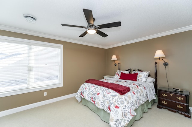 carpeted bedroom with ceiling fan, a textured ceiling, visible vents, baseboards, and crown molding