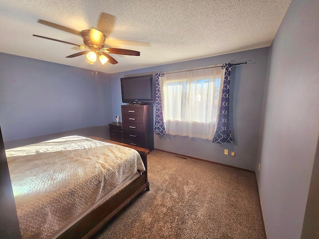 bedroom featuring carpet flooring, a textured ceiling, and ceiling fan