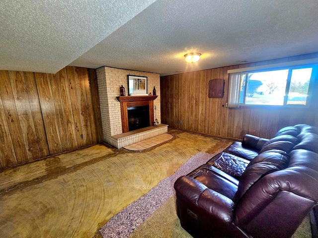 carpeted living room with a textured ceiling, a fireplace, and wooden walls