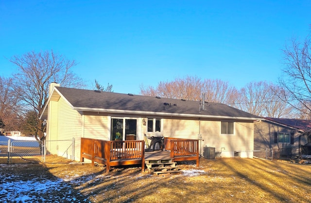 rear view of house featuring a wooden deck, a yard, and central air condition unit