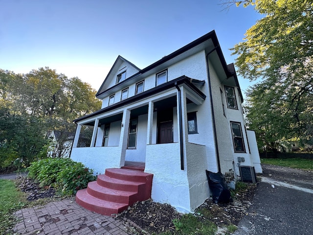 view of front of home with covered porch and central air condition unit