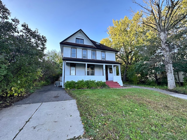 view of front of house featuring a porch and a front lawn