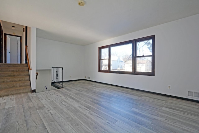 spare room with light hardwood / wood-style flooring