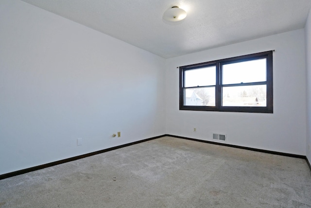 unfurnished room with light colored carpet