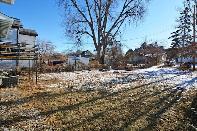 yard layered in snow with central AC