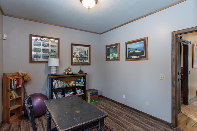 office featuring dark wood-type flooring, ornamental molding, and a textured ceiling