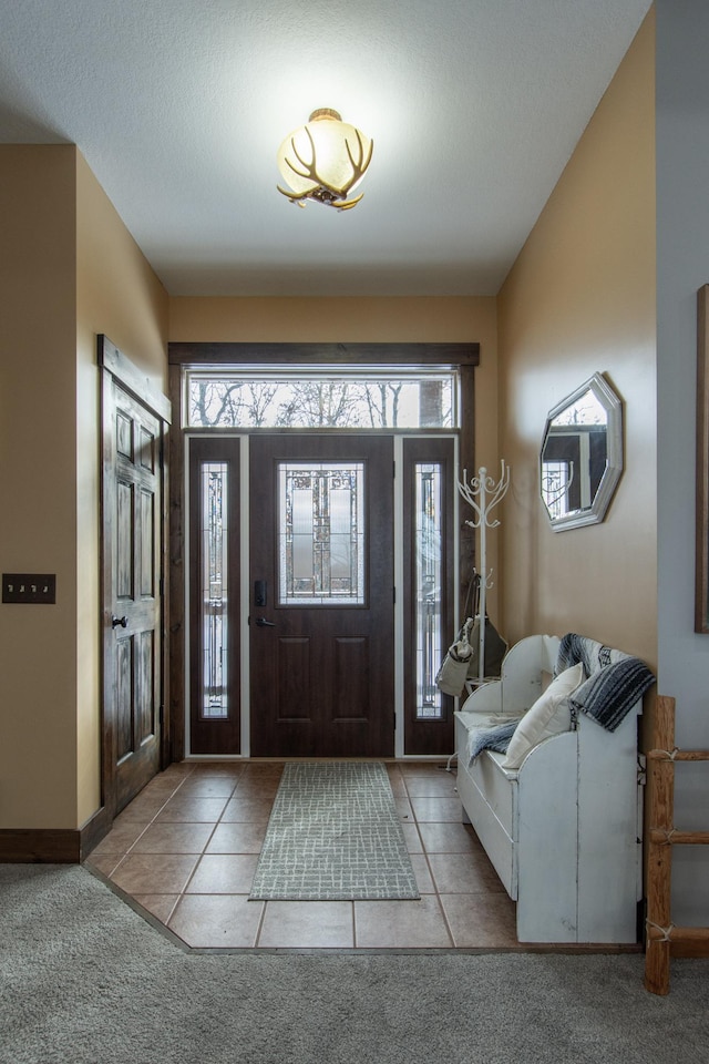 tiled entryway with a wealth of natural light